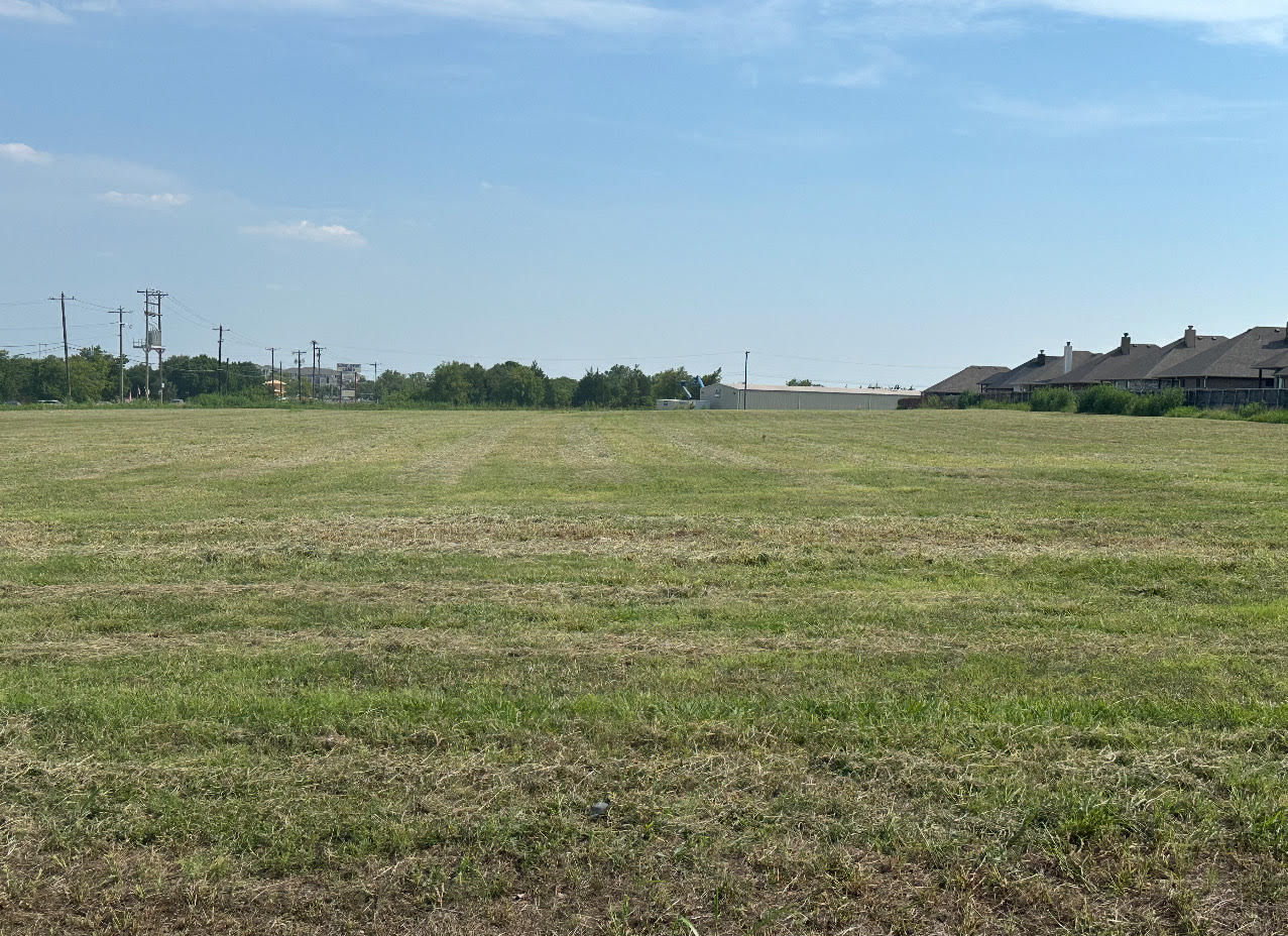 A large, freshly mowed pasture in Sherman, Texas, maintained by Yard Doctor’s professional pasture mowing service.